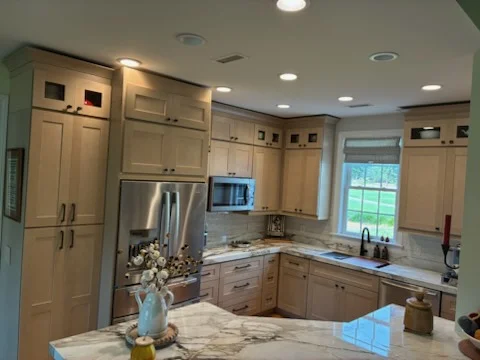 Kitchen remodel showcasing glass uppers and accent lighting
