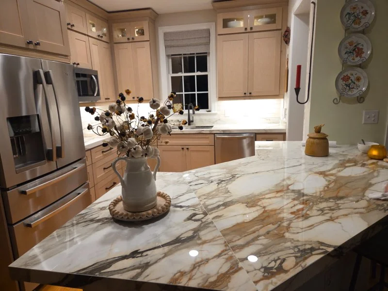 Renovated kitchen with island and custom lighting